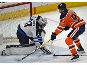 Edmonton Oilers Connor McDavid (97) will score on Winnipeg Jets goalie Connor Hellebuyck (37) during NHL action at Rogers Place in Edmonton, March 11, 2020.