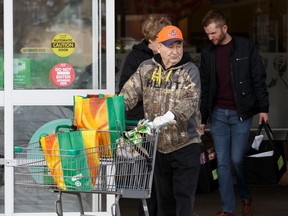 John and Morna Wowk load groceries into their SUV at Sobey's Belmont location at 13504 Victoria Trail in Edmonton, on Tuesday, March 17, 2020. The store has instituted an early morning opening to let seniors and vulnerable people shop for essentials during the ongoing COVID-19 pandemic.