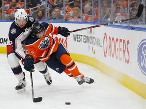 Columbus Blue Jackets defencemen Andrew Peeke (2) trips up Edmonton Oilers forward Kailer Yamamoto (56) at Rogers Place on Saturday March 7 2020.