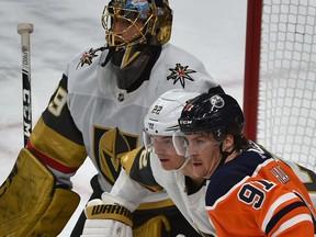 Edmonton Oilers' Gaetan Haas (91) and Vegas Golden Knights' Nick Holden (22) battle in front of goalie Marc-Andre Fleury at Rogers Place on Monday, March 9, 2020.