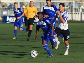 FC Edmonton midfielder Hanson Boakai moves the ball up field during the first half of their game against the Montreal Impact in the first leg of the Amway Canadian Championship semifinals at Clarke Stadium in Edmonton on Wednesday, May 7, 2014.