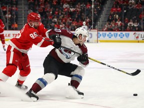 Ryan Graves #27 of the Colorado Avalanche tries to turn away from the stick of Sam Gagner #89 of the Detroit Red Wings during the third period at Little Caesars Arena on March 02, 2020 in Detroit, Michigan.