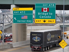 A commercial truck heads for the Ambassador Bridge , during the COVID-19 coronavirus outbreak, at the international border crossing, which connects with Windsor, Ont., in Detroit, Wednesday, March 18, 2020.