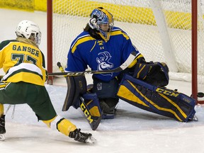 University of Alberta Pandas’ Kennedy Ganser (77) is stopped by the University of Lethbridge Pronghorns' Alicia Anderson (1) at Clare Drake Arena, in this file photo taken in Edmonton on Nov. 16, 2018. On Monday, both the Pronghorns men's and women's hockey programs were cancelled amid mounting budget constraints.