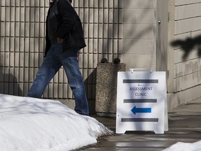 People enter a COVID-19 assessment clinic in Edmonton, on Tuesday, March 24, 2020.