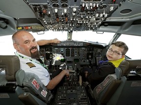 Tyler Palmowski (right) and Flair Airlines pilot Jim Ritchie (left) take a Boeing 737-400 aircraft for a spin around the runways at Edmonton International Airport on Monday April 6, 2020. Tyler has terminal cancer and one of the things on his "bucket list" was to pilot an airplane. Flair Airlines reached out to the family and made his dream come true.