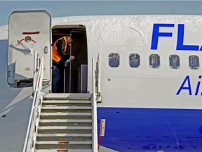 Flair Airlines maintenance manager Darryl Balaban sanitizes a Boeing 737-400 aircraft at Edmonton International Airport on Monday April 6, 2020.