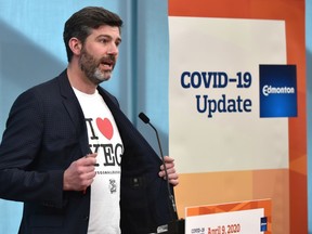 Mayor Don Iveson shows off his I love YEG t-shirt while providing an update on the city's response to COVID-19 during a news conference at city hall in Edmonton on Thursday, April 9, 2020.