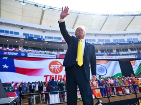 This file photo taken on February 24, 2020, shows US President Donald Trump waving after attending the 'Namaste Trump' rally at Sardar Patel Stadium in Motera on the outskirts of Ahmedabad. There is no larger symbol of the global sports shutdown than cricket's 110,000-seater Sardar Patel Stadium in Ahmedabad, opened by Trump in February 2020, but yet to see a ball bowled.