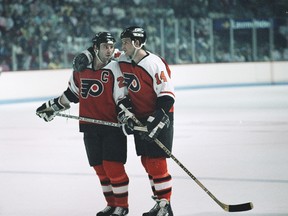 Philadelphia Flyers captain Dave Poulin #20 and teammate Ron Sutter #14 during a break in the action  at the Montreal Forum during the Wales Conference finals in 1987.