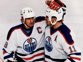 Edmonton Oilers Wayne Gretzky, left, and Mark Messier embrace after a goal was scored against the Los Angeles Kings in Edmonton, during Game 5 on April 14, 1987 of the division semifinals. The Oilers went on to win their 3rd Stanley Cup on May 31.