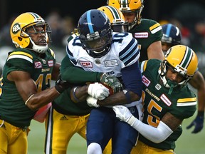 The Edmonton Eskimos defence takes down Toronto Argonauts receiver Armanti Edwards (10) at Commonwealth Stadium on Oct. 14, 2017.