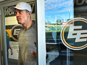 Eskimos quarterback Trevor Harris opens a door with Commonwealth Stadium reflected off the glass, on his way to speak to the media at the end of the CFL season on Nov. 18, 2019.