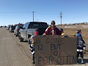 Fans and supporters line the highway on Monday, April 13, 2020, near North Battleford, Sask., in support of Edmonton Oilers forward Colby Cave, who died at a Toronto hospital on Saturday, April 11, 2020, after suffering a brain bleed. He was 25.