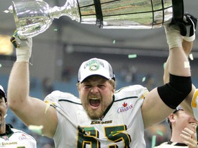 Kevin Lefsrud hoists the Grey Cup after the Edmonton Eskimos defeated the Montreal Alouettes at BC Place Stadium in Vancouver in this file photo from November 27, 2005.