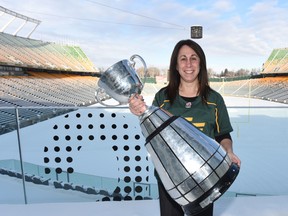 Edmonton Eskimos board of director chair Janice Agrios poses with the Grey Cup in this undated photo taken on the balcony outside the club offices at Commonwealth Stadium. (Supplied photo)