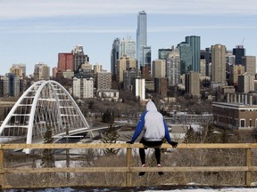 A lone jogger takes a break and looks out at the Edmonton skyline in the age of COVID-19 social isolation, Friday April 10, 2020.