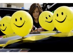 Assistant Principal Paula Borges-Couture decorates her vehicle as teachers and staff from St. Jerome Elementary School, prepare to hold a car parade through the Rundle Heights and Abbotsfield neighbourhoods, in Edmonton April 29, 2020.