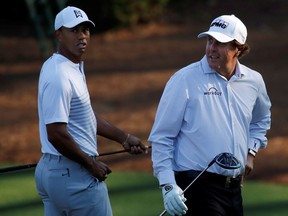 U.S. golfers Tiger Woods (left) and Phil Mickelson walk to the 11th tee during practice for the 2018 Masters at Augusta National Golf Club in Augusta, Georgia, April 3, 2018.