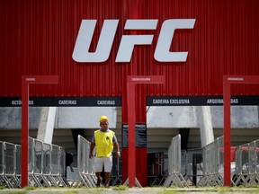 A man walks in front of the Nilson Nelson Gymnasium as the next UFC Fight Night will be held without fans during the fights, after reports of the coronavirus in Brasilia, Brazil, March 12, 2020.