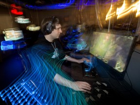 OverKlocked Gaming owner Tim Cooper plays a game in his empty e-sports gaming shop in Edmonton on May 19, 2020. While the COVID-19 shutdown measures have impacted his business immensely, Cooper is planning a charity gaming event to raise funds and food for Edmonton's Food Bank on June 5, 2020.