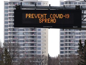 Canadian flags on the balconies of the 19 storey Riverwind Condos on Saskatchewan Dr., to show solidarity for the COVID-19 battle in Edmonton, April 14, 2020.