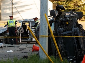 Edmonton Police Service officers investigate a two-vehicle fatal collision on the one-way 100 Avenue at 167 Street in Edmonton on Wednesday, May 27, 2020.