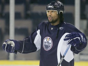 Edmonton Oilers forward Georges Laraque gestures as he has an animated discussion with teammate Brad Winchester during team practice at Rexall Place in Edmonton on Friday June 16, 2006.