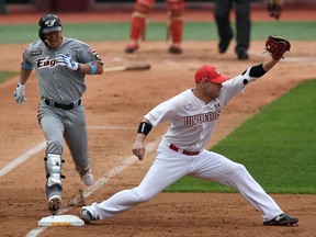 SK Wyverns infielder Jamie Romak (R) forces out Hanwha Eagles' Ha Ju-suk (L) at first base in the second inning during the opening game for South Korea's new baseball season at Munhak Baseball Stadium in Incheon on May 5, 2020.