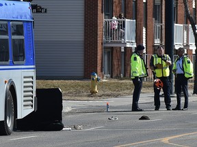 Members of the Edmonton Police Service collision investigation unit at the scene of collision between an Edmonton Transit bus and a pedestrian on 118 Avenue and 50 Street in Edmonton on April 15, 2020.