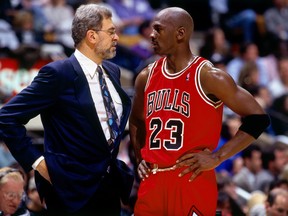 Michael Jordan of the Chicago Bulls  talks strategy with head coach Phil Jackson in Game 6 of the 1996 NBA Finals against the Seattle SuperSonics at the United Center on June 16, 1996 in Chicago Iillinois.
