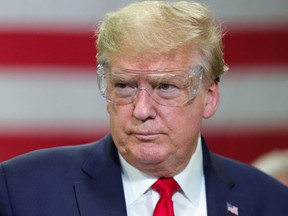 U.S. President Donald Trump looks at an assembly line during a tour of Honeywell's facility manufacturing protective face masks for the coronavirus disease outbreak in Phoenix, Ariz., Tuesday, May 5, 2020.