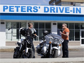 Nicholas Bunes, left, and his father Richard Bunes enjoy lunch at the newly opened Peters' Drive-in, 5151 Calgary Trail, in Edmonton on Tuesday, May 5, 2020. The drive-thru is now open from 10 a.m. to 10 p.m.