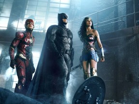 This image released by Warner Bros. Pictures shows Ezra Miller, from left, Ben Affleck and Gal Gadot in a scene from "Justice League." (Warner Bros. Entertainment Inc. via AP)