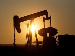 An oil pump jack pumps oil in a field near Calgary, Alberta, Canada on July 21, 2014.