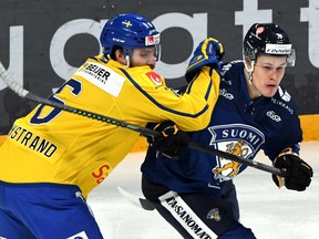 Sweden's Mikael Wikstrand skates against Finland's Jesse Puljujarvi in the Euro Hockey Tour's Karjala Cup in Finland on Nov. 10, 2019.