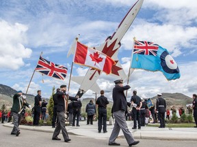 Flags are carried at a tribute ceremony to honour Capt. Jennifer Casey at the Kamloops Airport on May 21, 2020. A procession honouring the Canadian Forces Snowbirds aerobatic team member who was killed in recent a plane crash will make its way through the streets of Halifax this evening.