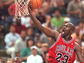 Chicago Bulls’ Michael Jordan drives to the hoop during as Charlotte Hornets’ J.R. Reid looks on from under the basket in during a playoff game on May 10, 1998. Jordan and the Bulls’ 1997-98 championship run is the subject of The Last Dance, a new documentary on Netflix.  File photo