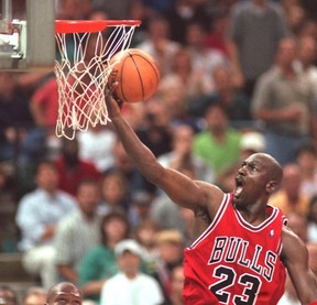 Chicago Bulls’ Michael Jordan drives to the hoop during as Charlotte Hornets’ J.R. Reid looks on from under the basket in during a playoff game on May 10, 1998. Jordan and the Bulls’ 1997-98 championship run is the subject of The Last Dance, a new documentary on Netflix.  File photo