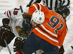 Edmonton Oilers Gaetan Haas puts a head lock on Chicago Black Hawks Zack Smith  in Edmonton on Feb. 11, 2020. Should the NHL return to play to close out the season, a meeting between the two teams appears imminent.