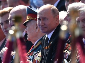 President of Russia and Commander-in-Chief of the Armed Forces Vladimir Putin watches a Victory Day military parade on Red Square, marking the 75th anniversary of the victory in World War II, on June 24, 2020 in Moscow, Russia.