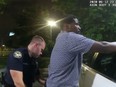 Former Atlanta Police Department officer Garrett Rolfe searches 27-year-old Rayshard Brooks in a Wendy's restaurant parking lot in a still image from the video body camera of officer Devin Bronsan in Atlanta, Ga, June 12, 2020.