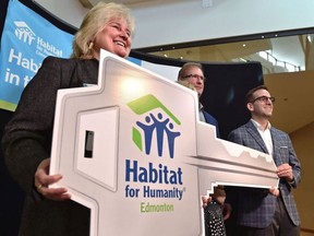 Karen Stone, President and CEO of Habitat for Humanity, left, Shane Erikson, Qualico Vice-President for Northern Alberta and Ian MacDonald, Habitat Board Chairman, celebrate Habitat Day on April 25, 2019, as local homebuilders announce their support of Habitat for Humanity in the Capital Region. Ed Kaister/ PostMedia