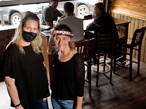 Garrison Pub general manger Shannon Roy, left and server Alexis Cooley were photographed in the pub on Monday, June 8, 2020.