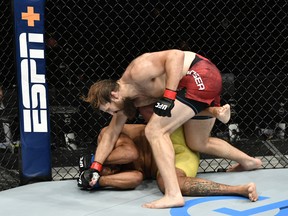 In this handout image provided by UFC, Tanner Boser of Canada punches Raphael Pessoa of Brazil in their heavyweight fight during the UFC Fight Night event inside Flash Forum on UFC Fight Island on July 26, 2020 in Yas Island, Abu Dhabi, United Arab Emirates.
