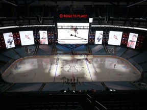 The Edmonton Oilers and the Calgary Flames watch a tribute to Colby Cave prior to an exhibition game prior to the 2020 NHL Stanley Cup Playoffs at Rogers Place on July 28, 2020 in Edmonton.