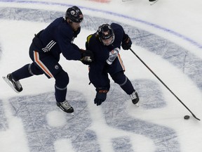Kailer Yamamoto (56) battles Leon Draisaitl (29) during the first day of the Edmonton Oilers training camp for the 2019-20 NHL's return to play at Rogers Place on Monday, July 13, 2020.