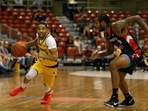 Edmonton Stingers guard Xavier Moon (2) battles Fraser Valley Bandits' Jelan Kendrick (9) in this file photo from Northlands Expo Centre in Edmonton on Aug. 1, 2019.