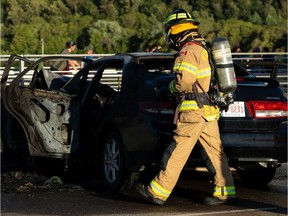 An Edmonton Fire Rescue Services firefighter responds to a two-vehicle crash on Walterdale Bridge on Tuesday, July 14, 2020.