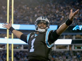 Cam Newton of the Carolina Panthers reacts after a touchdown against the Tampa Bay Buccaneers at Bank of America Stadium on January 3, 2016 in Charlotte, North Carolina.